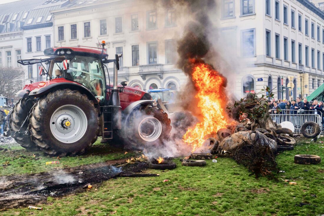 Road blocks ablaze: Farmers in Brussels protest free-trade deal ...